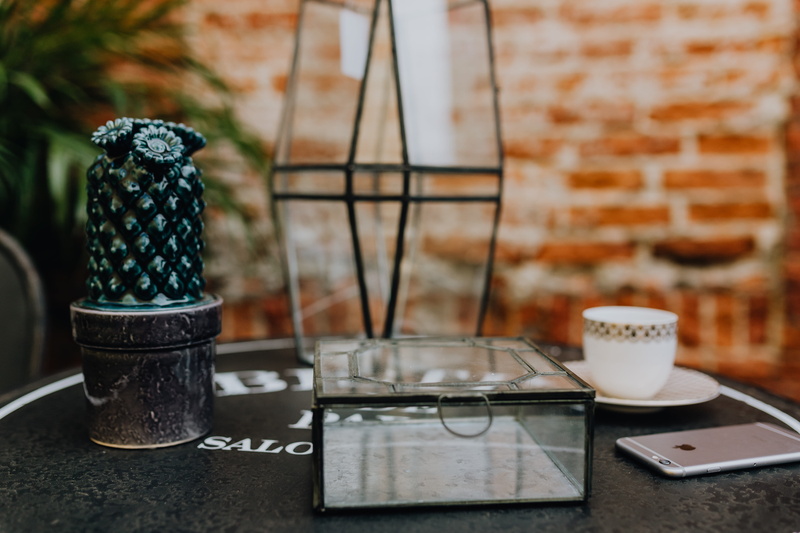 focus on foreground, kitchen utensil, no people, woman, outside, coffee cup, place mat, cup, coffee, bistro, grass, indoors, drink, wireless technology