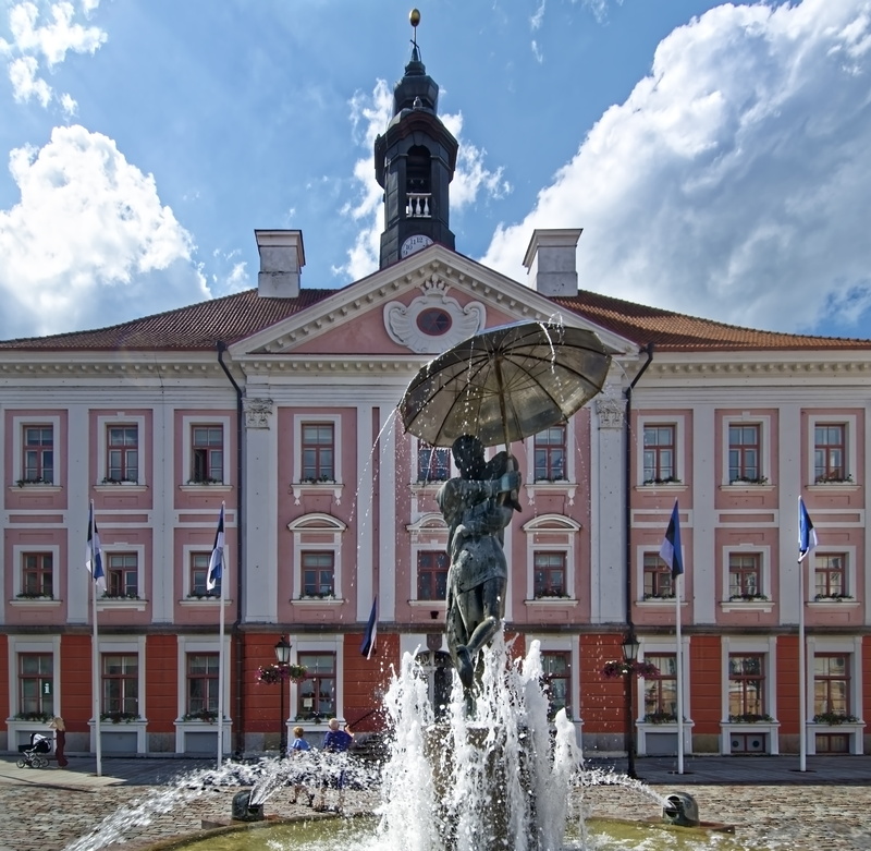 outdoors, no people, fountain, tartu, historically, cloud - sky, sky, baltic states, estonia, houses, city, built structure, day, motion, town hall, representation
