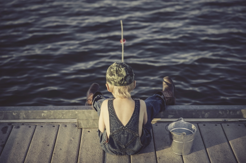 standing, statue, waist up, lifestyles, people, clothing, fishing, focus on foreground, lake, s, young childhood, one person, railing, boy, rear view, wearing