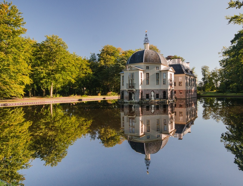 building, outdoors, europe, water, place of worship, tree, architecture, pond, white, religion, golden age, sky, history, clear sky, landscape, estate