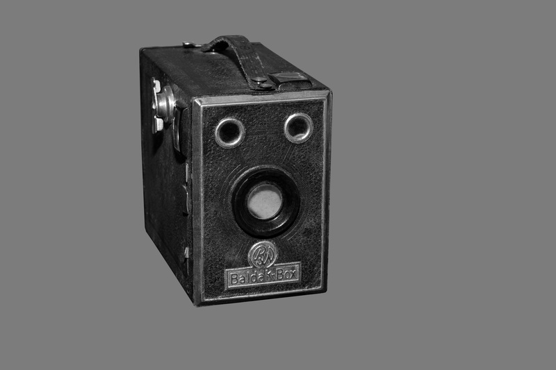 black background, still life, lens - optical instrument, antique, camera - photographic equipment, obsolete, studio shot, silver colored, historically