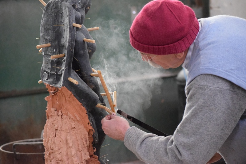 one person, wax, hat, side view, mature adult, adult, outdoors, working, clothing, men, mature men, occupation, merger, making, holding, items, statue