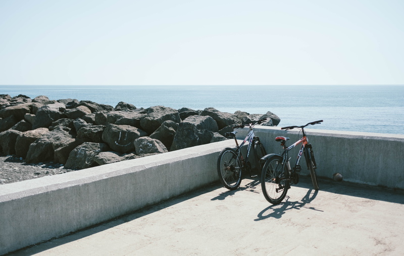 scenic, vacation, tranquility, ocean, gray, land, bicycles, sky, horizon over water, sun, sea, seashore, tranquil scene, wall, horizon, nature, behind