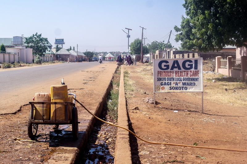 architecture, information sign, sunlight, sky, human, nature, sign, day, nigeria, no people, north, dry, city, building, kegs, western script, water, urban