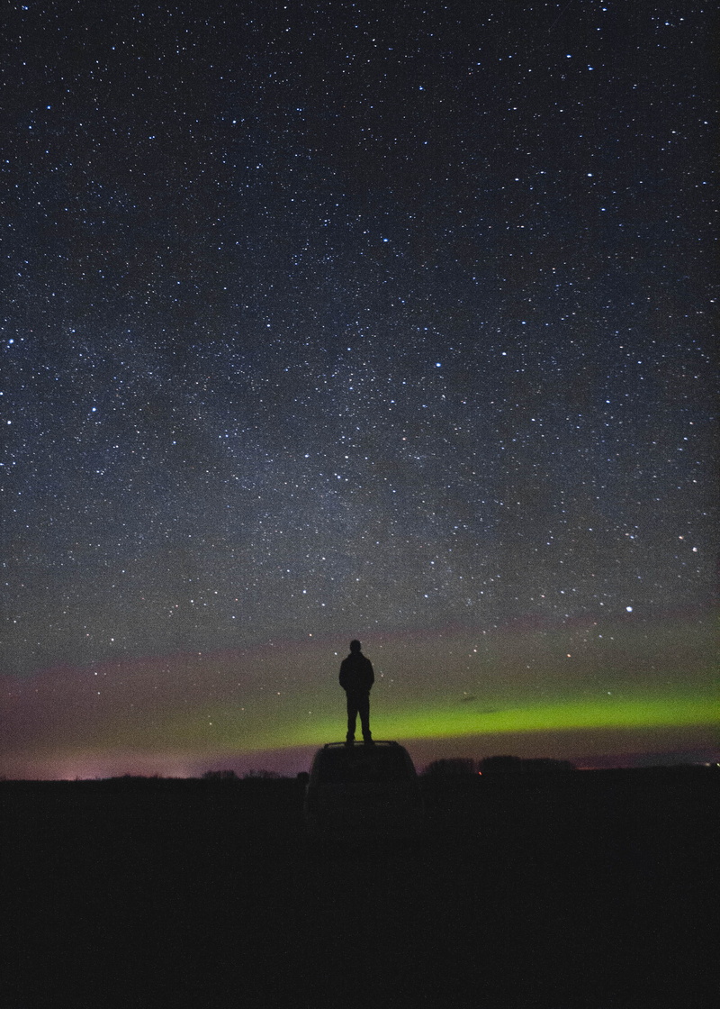 beauty in nature, real people, northern lights, outdoors, leisure activity, nature, infinity, star - space, tranquility, canada, space, lifestyles, person