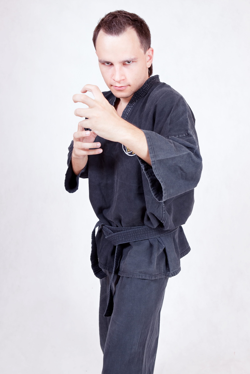 looking at camera, health, lifestyle, black color, clothing, communication, holding, uniform, sport, fighter, portrait, karate, men, man, standing, one person