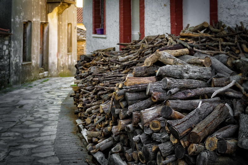 outdoors, building exterior, firewood, place of worship, day, footpath, building, large group of objects, architectural column, stack, built structure