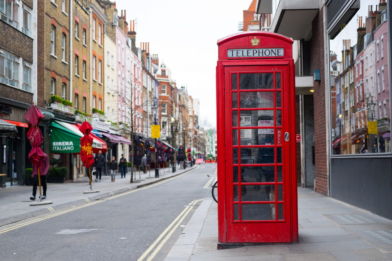 street, outdoors, architecture, communication, sidewalk, transportation, built structure, united kingdom, telephone booth, city, reflection, city street