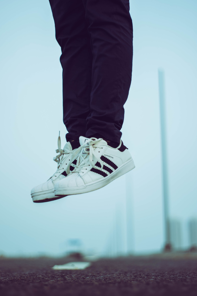 street, human leg, body part, jump, human body part, unrecognizable person, adidas, real people, man, day, mid-air, nature, human foot, leisure activity