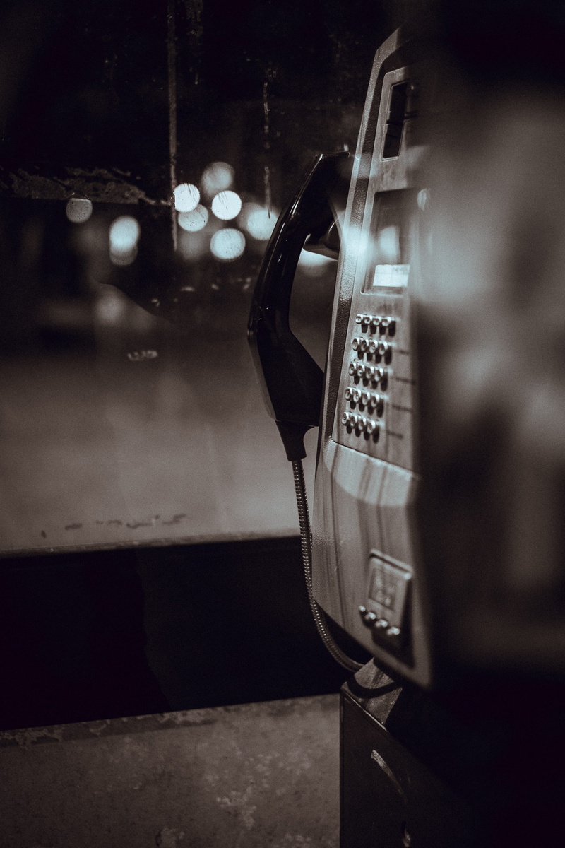 bokeh, indoors, selective focus, retro styled, focus on foreground, glass - material, grayscale, telephone receiver, still life, station, technology, phone