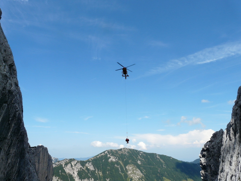 rescue helpers, solid, real people, adventure, leisure activity, beauty in nature, mountain range, rock formation, low angle view, rescue, rotor, outdoors