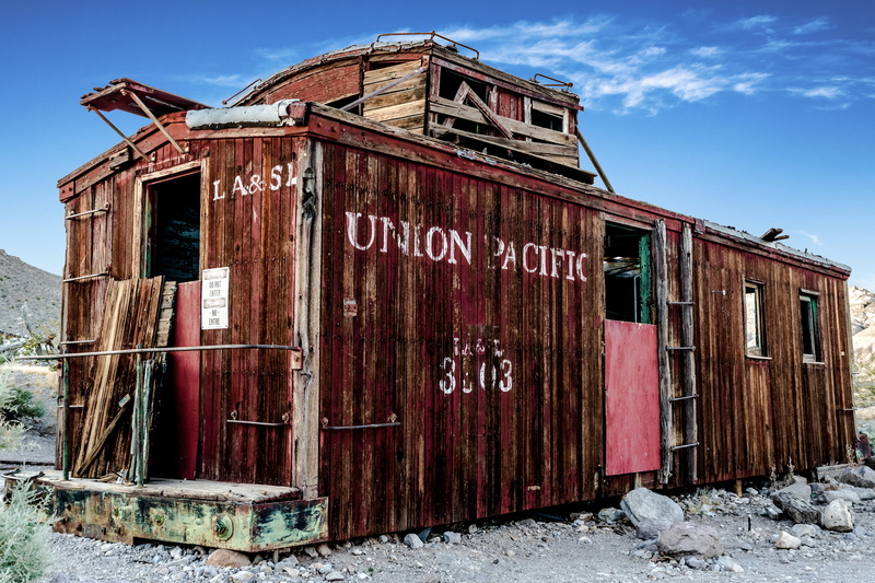 abandoned, building exterior, communication, cloud - sky, old, wooden, run-down, train, built structure, deterioration, rusty, no people, tree, unit, grass