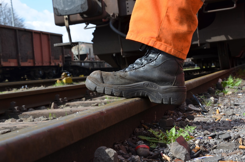 leather, railway tracks, railway, goods wagons, shoe, track, transportation, black, men, metal, occupation, one person, railroad Station Platform, rail