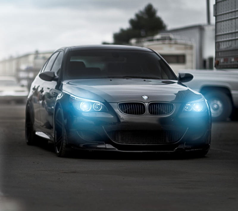 street, BMW M5, outdoors, blue, blue eyes, car, land vehicle, white color, city, stationary, day, close-up, motor vehicle, no people, architecture, black cars