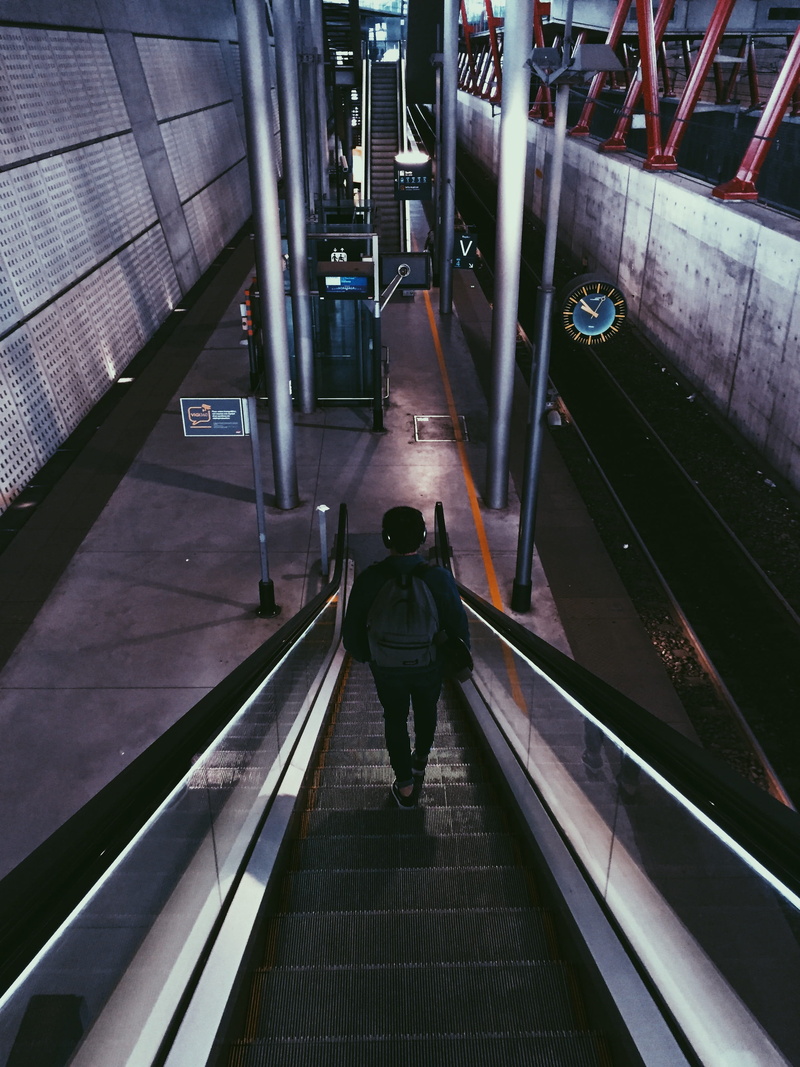 escalator, architecture, railing, illuminated, rear view, moving walkway, machine, steps and staircases, direction, terminal, walking down, handrail, built structure