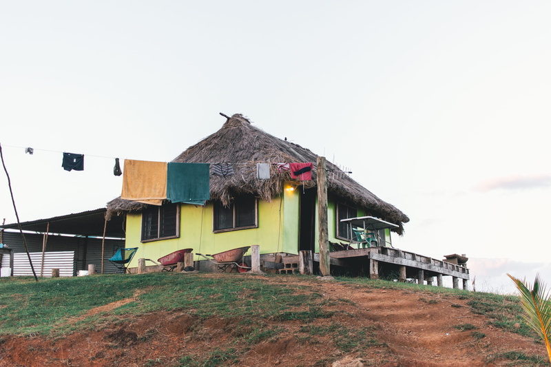 building, plant, countryside, person, clear sky, house, built structure, light, sunrise, sky, grass, copy space, island life, day, traffic light, housing
