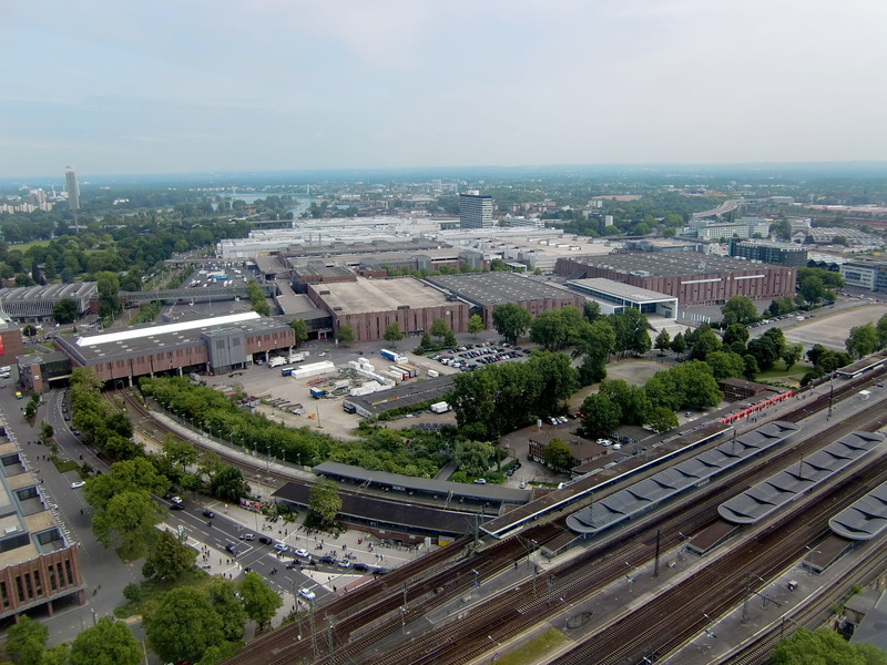 motor vehicle, fair, city, mode of transportation, building exterior, Railway Station, railroad track, day, aerial view, architecture, tree, 2K, plant