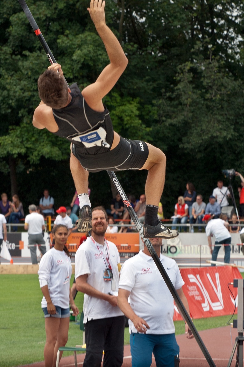 group of people, men, three quarter length, human arm, effort, lifestyles, athletics, focus on foreground, holding, real people, motion, people, sport