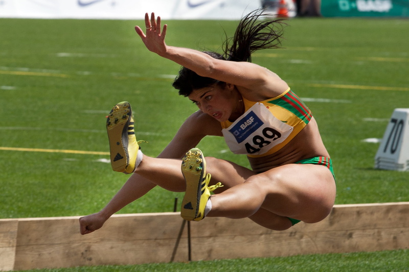 human body part, athlete, one person, jumping, track and field athlete, sport, human limb, field, track and field, outdoors, limb, young adult, arms raised