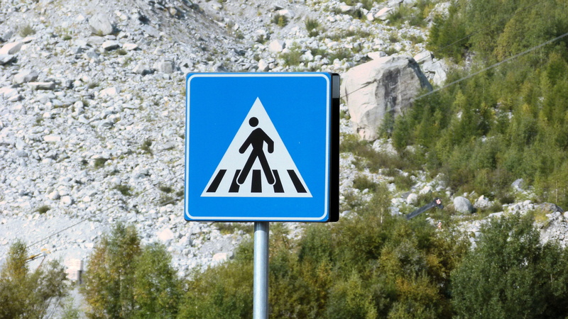 human representation, warning sign, communication, tree, pedestrian, direction, 4K, mountain, text, outdoors, transportation, blue, road, signalling, arrow symbol