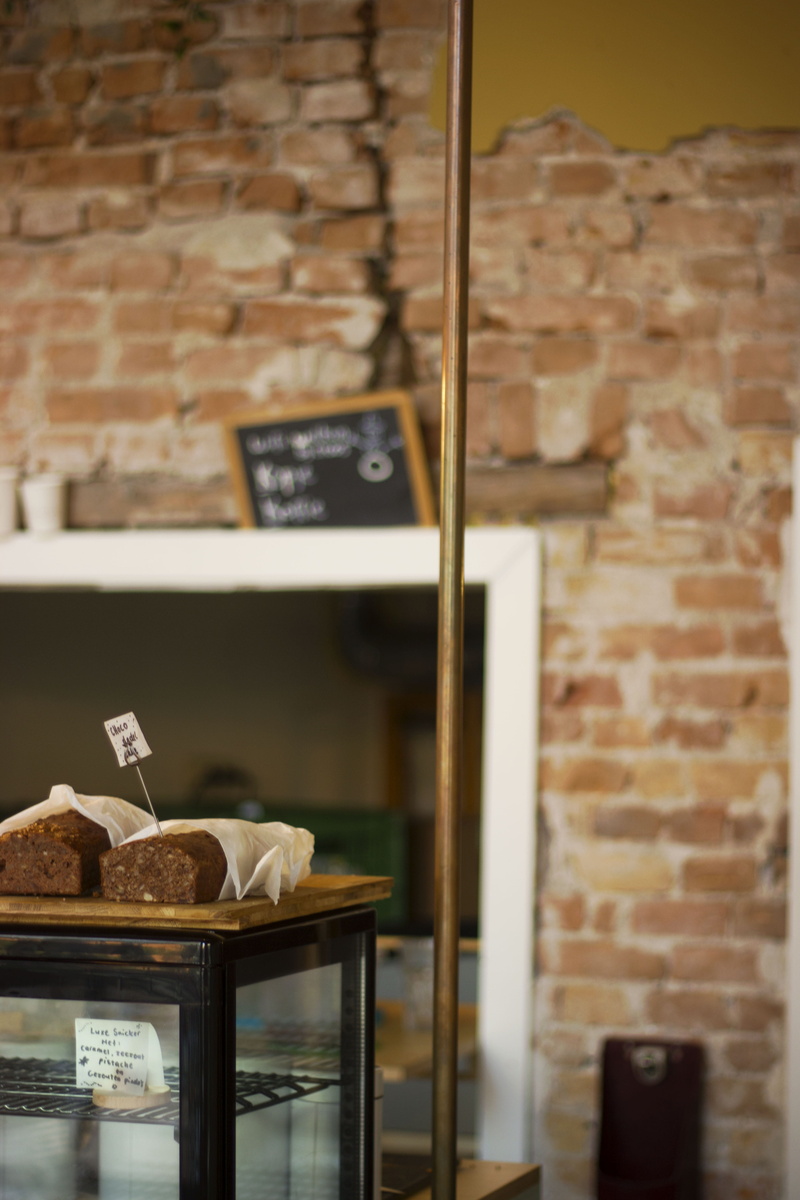 exposed brick, text, still life, retail display, indoors, bread, business, lifestyle, brick, retail, no people, brick wall, shelf, bistro, focus on foreground
