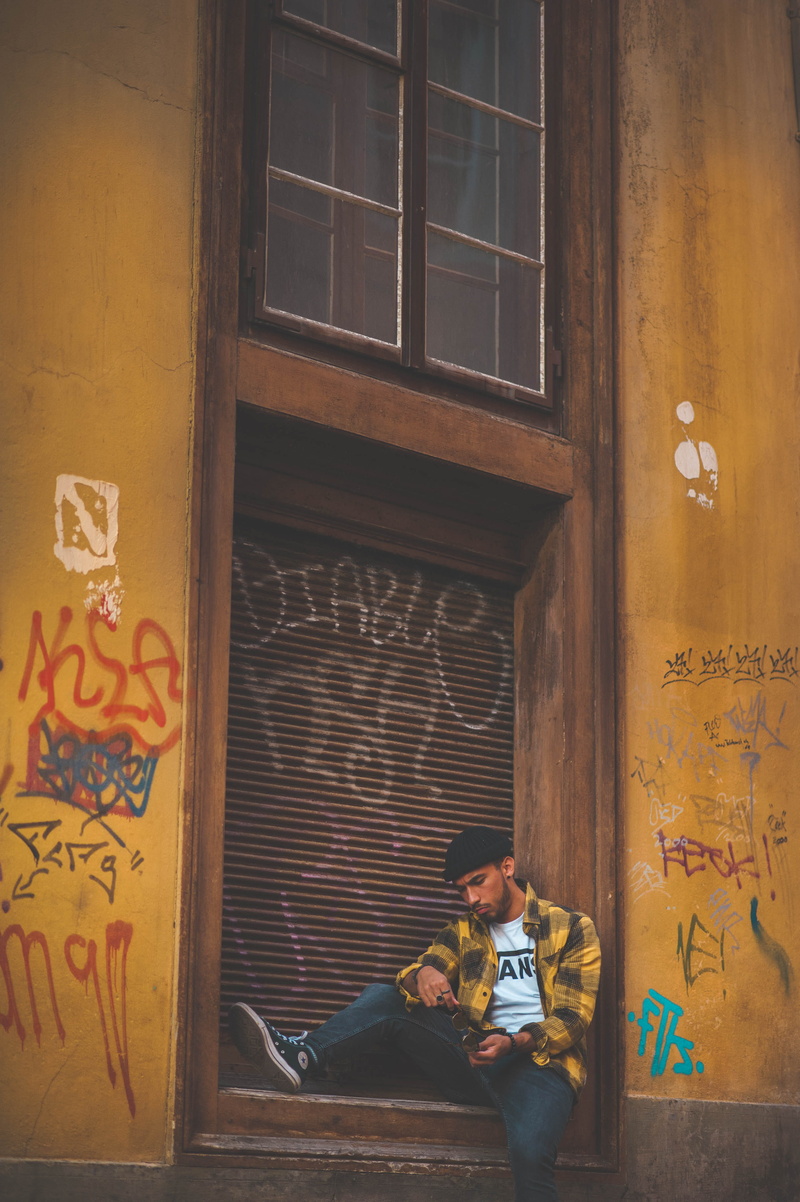 fashion, people, one person, wall, guitarist, man, leisure activity, style, day, architecture, shutter, young men, lifestyles, performer, full length, male