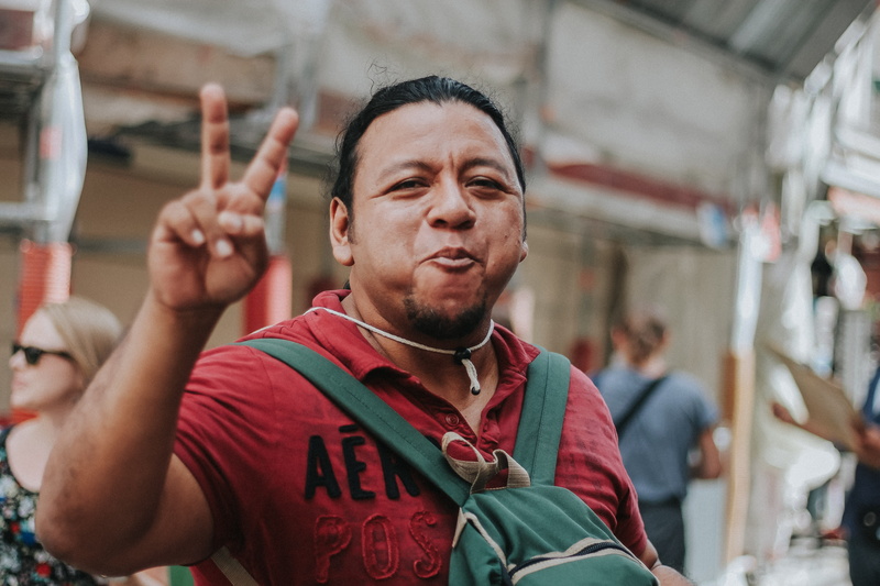 focus on foreground, portrait, backpacker, man, france, peace, waist up, arts culture and entertainment, men, front view, candid, smile, sign, making, leisure activity