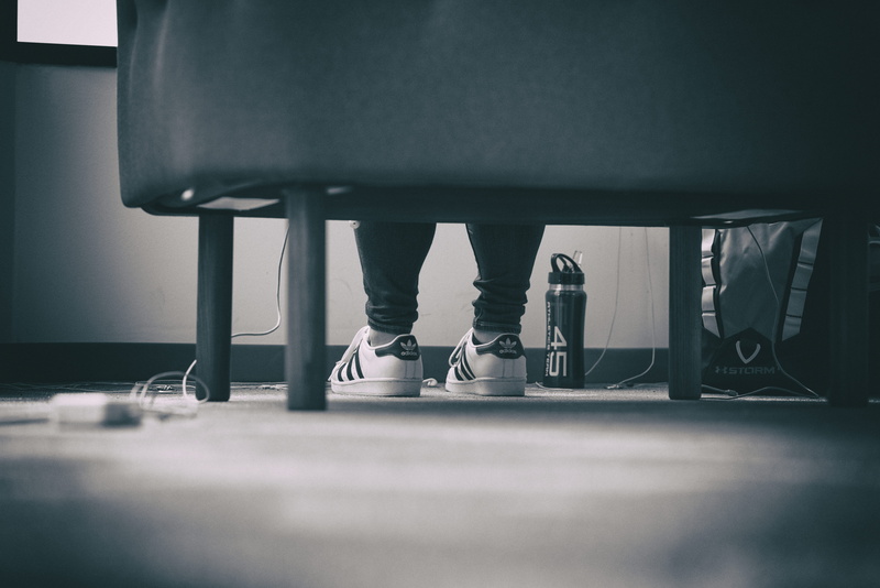 sitting, bottle, people, business person, sofa, contrast, limb, bag, white, adidas, photo, selective focus, two people, surface level, grayscale, messy