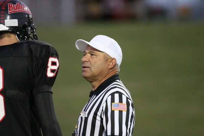 referee, american football field, friendly, mature adult, player, competition, side view, football Player, cap, competitive Sport, mature men, two people