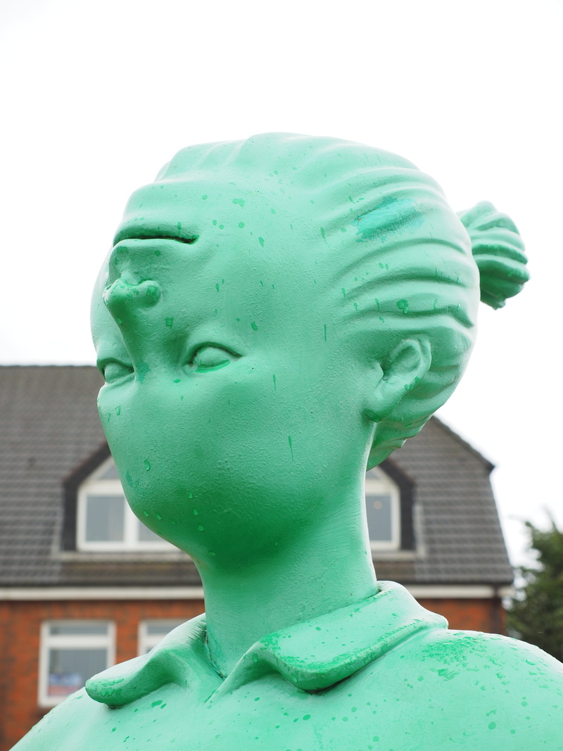 figures, focus on foreground, the traveler a giant in the wind, green color, close-up, martin cloud, human, built structure, craft, green, outdoors, riesen