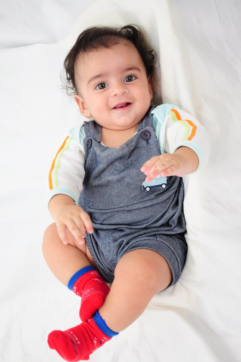 fashion baby, gay baby, bed, high angle view, baby, smiling, one person, happiness, front view, lying, happy baby, babyhood, nenen cuddly, innocence, full length