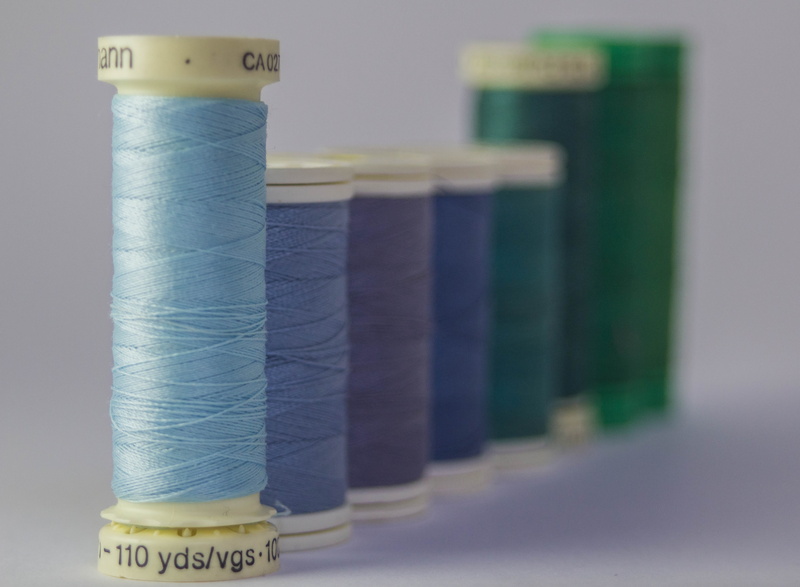 no people, large group of objects, order, blue, bokeh, still, treads, spools, color, indoors, still life, stack, business finance and industry, group, colors