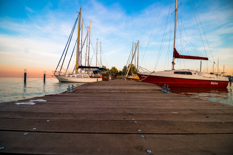 sky, harbor, boats, water, transportation, beach, pole, ocean, dock, tranquility, mode of transportation, clouds, nature, brown, items, yachts, yacht, beauty in nature