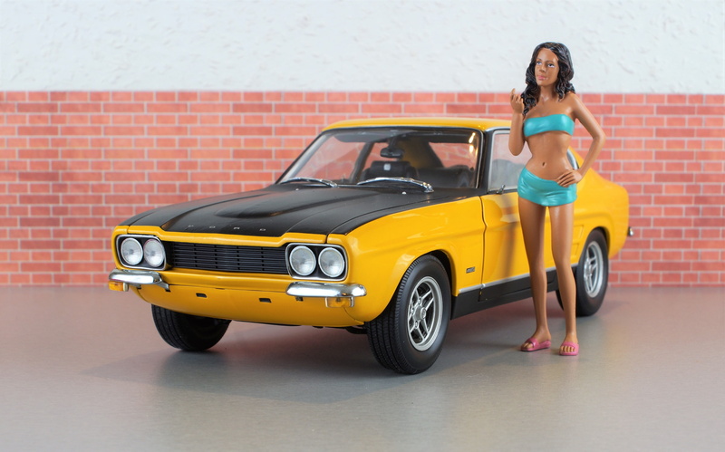 model car, mode of transportation, adult, sports car, hairstyle, front view, young women, capri, women, auto, beautiful woman, diorama, hood, vehicle, motorsport