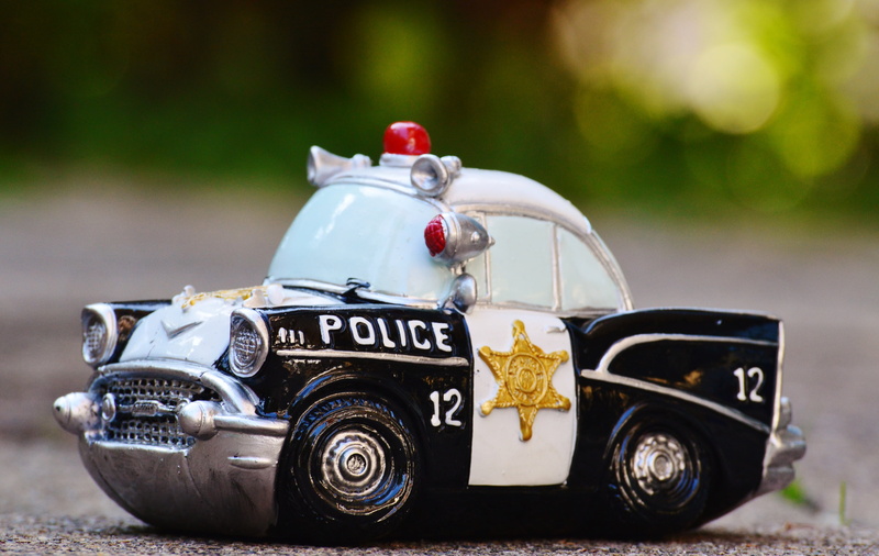 scale, model, focus on foreground, headwear, police car, white, photography, security, toy, miniature, no people, police, patrol car, protection, focus