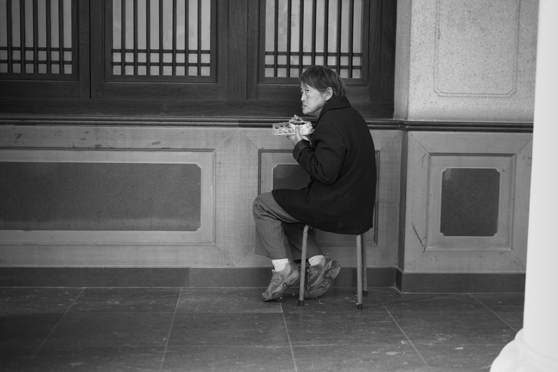 one person, eating, seat, women, jingan, side view, old, architecture, temple, built structure, food, chair, worried, portrait, casual clothing, religion