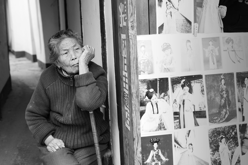 lifestyles, winter, pause, warm clothing, walking stick, one person, window, mature adult, stare, china, old, standing, shanghai, leisure activity, sitting