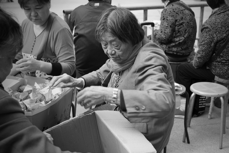 sitting, lifestyles, seat, travel, black and white, worship, men, leisure activity, senior women, chinese, real people, casual clothing, senior men, incidental people
