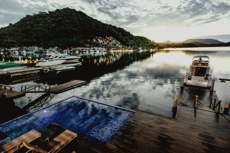 nautical vessel, lake, dock, pier, plant, day, port, mar, reflection, nature, yacht, outdoors, mode of transportation, brazil, architecture, built structure