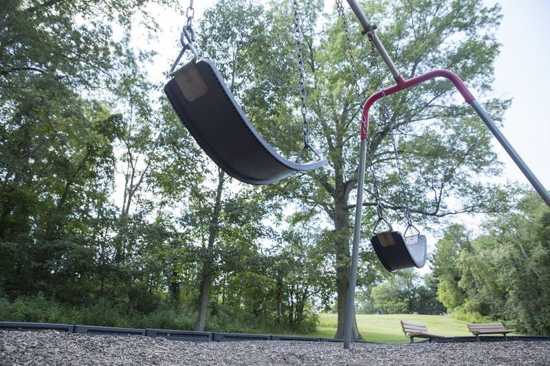 park, beauty in nature, no people, river, playground, lighting equipment, trees, street light, outside, swingset, day, safe surfacing, nature, view from below