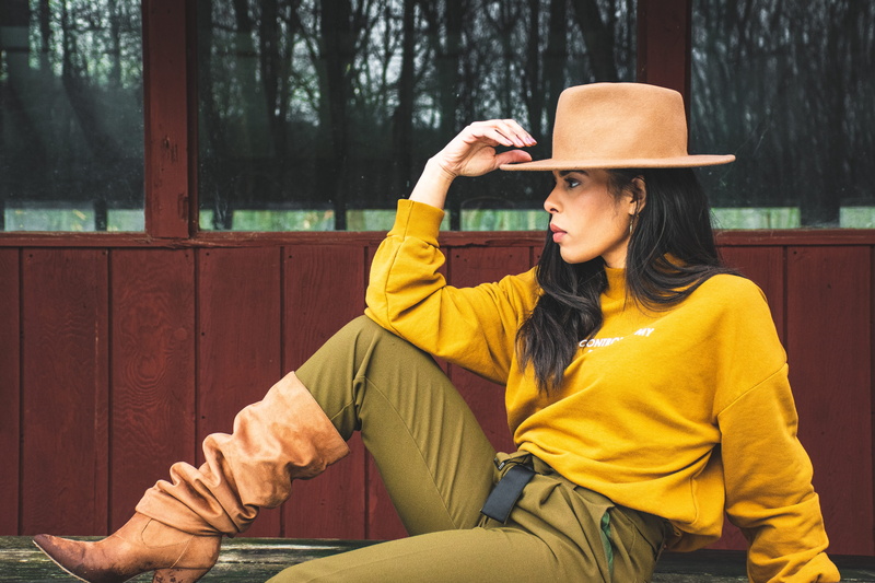 hand, side view, person, daylight, waist up, clothing, hat, female, blurred background, young adult, pretty, pose, hairstyle, daytime, winter, woman, young