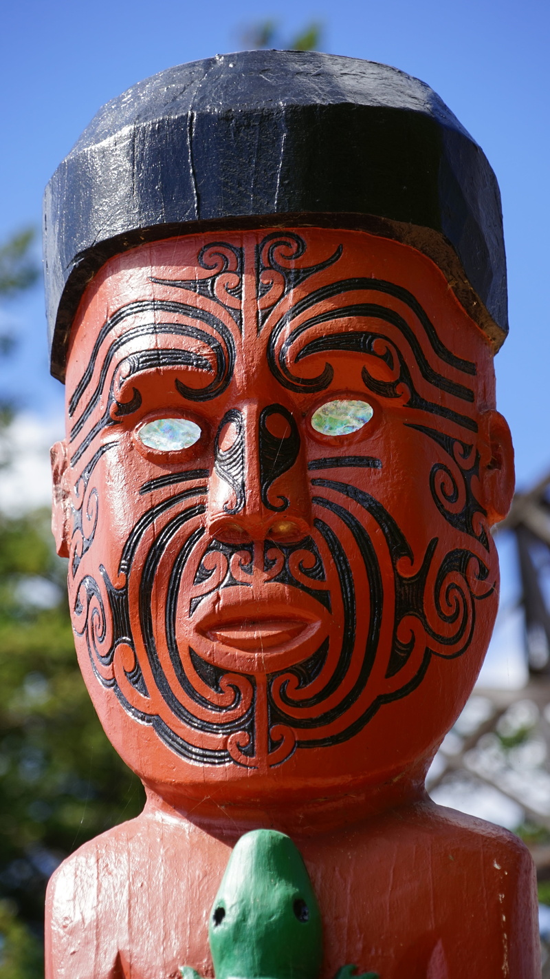 face, day, sunlight, creativity, focus on foreground, male likeness, sculpture, figure, holzfigur, maori, red, representation, spirituality, craft, no people