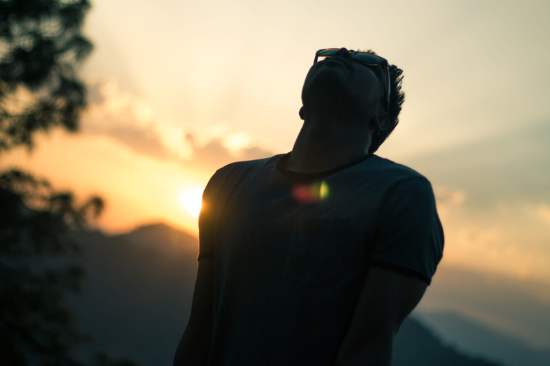 waist up, obscured face, standing, travel, sky, outdoors, young adult, man, sunglasses, handsome, three quarter length, one person, lifestyles, silhouette