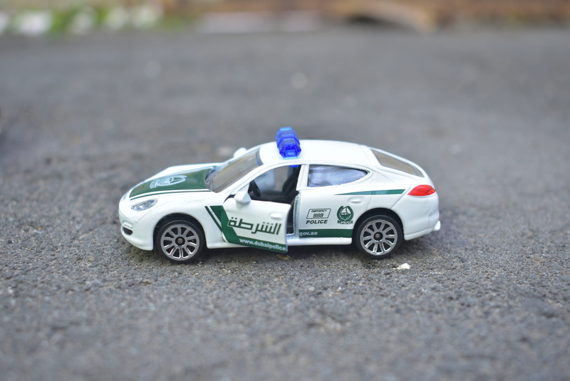 outdoors, police, street, car, still life, miniature, auto, vehicle, transportation, motor vehicle, mode of transportation, diecast, blue, road, toy car
