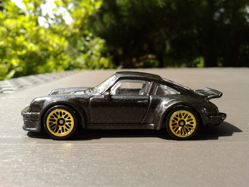 toy, motor vehicle, diecast, 911, tree, hot wheels, mode of transportation, land vehicle, transportation, selective focus, no people, 934 rsr, porsche turbo