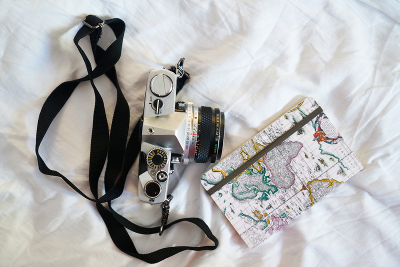 photo, directly above, camera - photographic equipment, high angle view, close-up, Notebook, sheet, travel, 5K, day, bedroom, bed, shoe, studio shot, Book