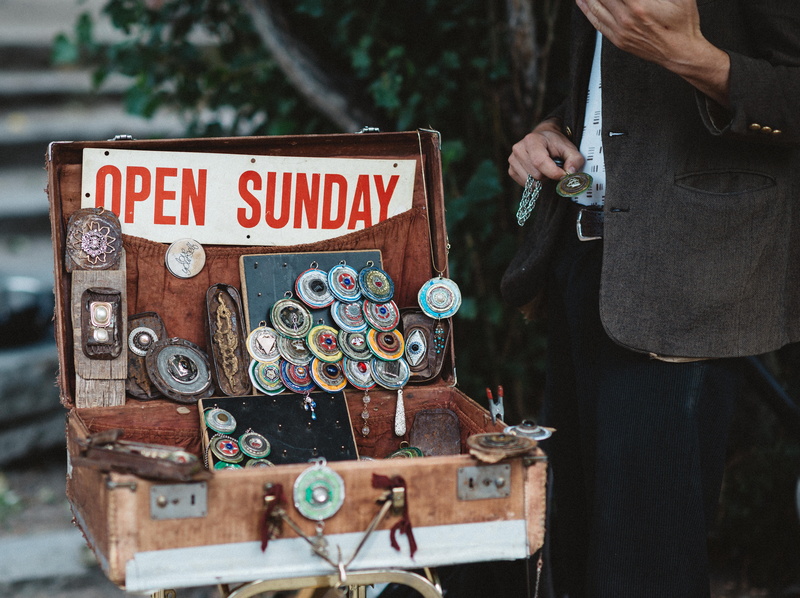 jewellery, accessory, upcycle, focus on foreground, person, human body part, beside, silver, communication, day, text, sale, sign, colored, briefcase, retail