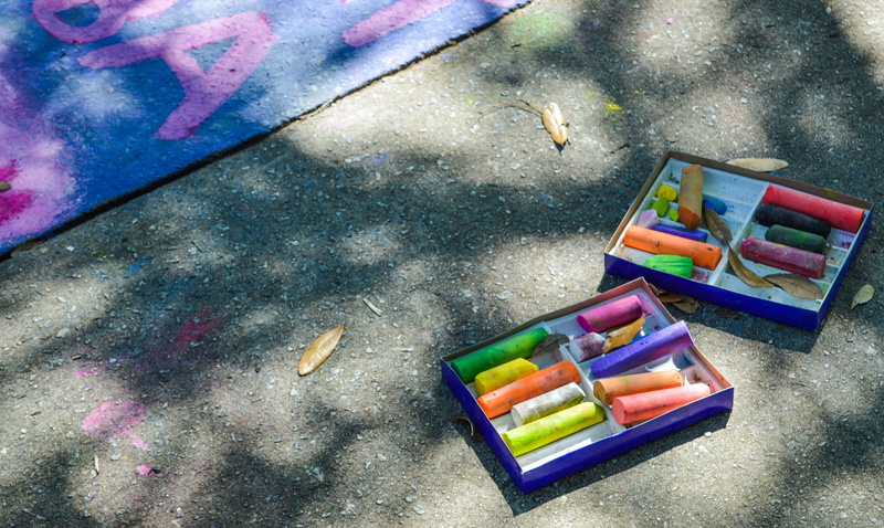 no people, art and craft, still life, high angle view, chalk, box, multi colored, close-up, outdoors, art, crayon, art and craft equipment, purple, flooring