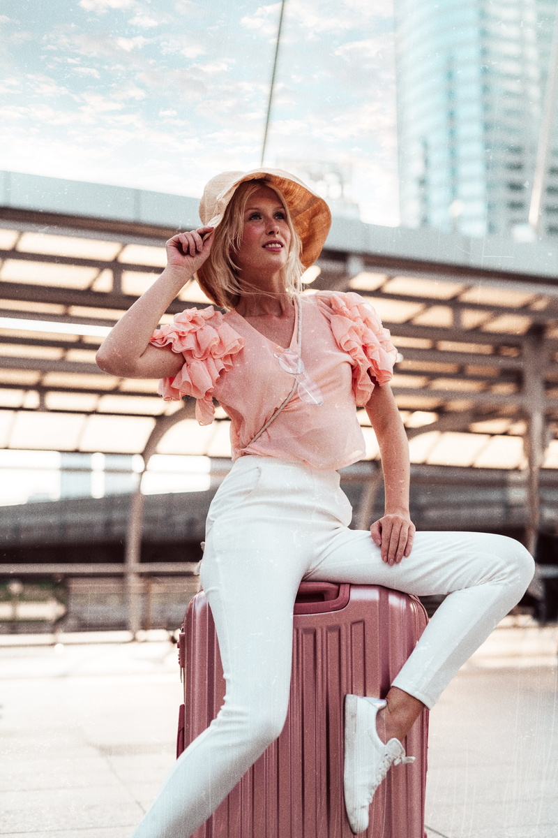 sitting, girl, front view, young women, russian, leisure activity, casual clothing, trip, suitcase, luggage, adult, smiling, woman, day, case, focus on foreground