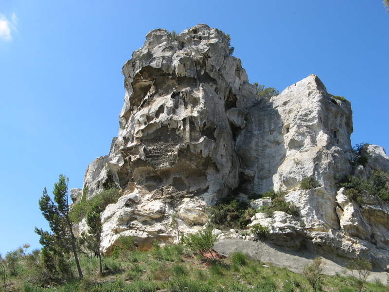 rock formation, solid, low angle view, eroded, tranquil scene, mountain, physical geography, sky, sunlight, outdoors, formation, beauty in nature, clear sky
